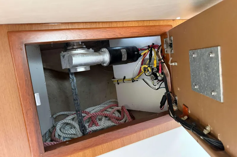 Slide: The Image of 2008 Henriques 30 Express boat interior wiring and rope storage compartment. - 66