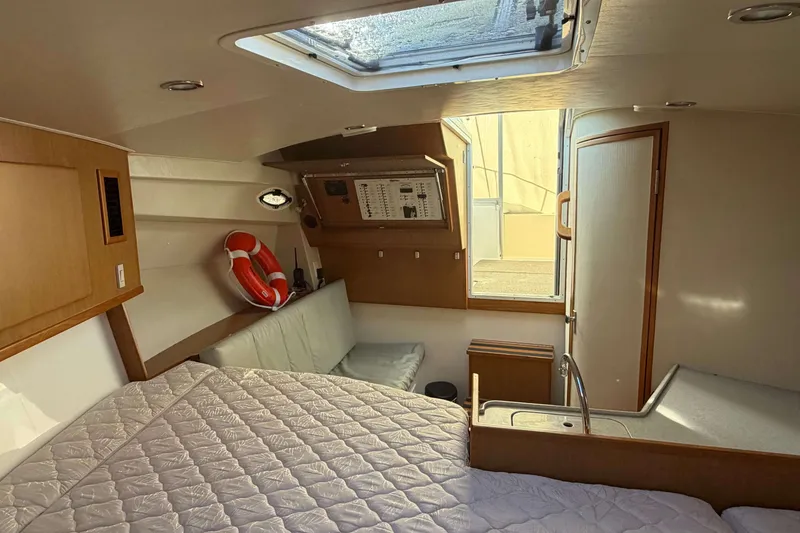 Slide: The Image of 2008 Henriques 30 Express cabin interior with bed, seating, and life preserver. - 67