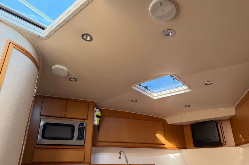 Slide: The Image of Interior of 2008 Henriques 30 Express boat with skylight, microwave, and TV. - 74