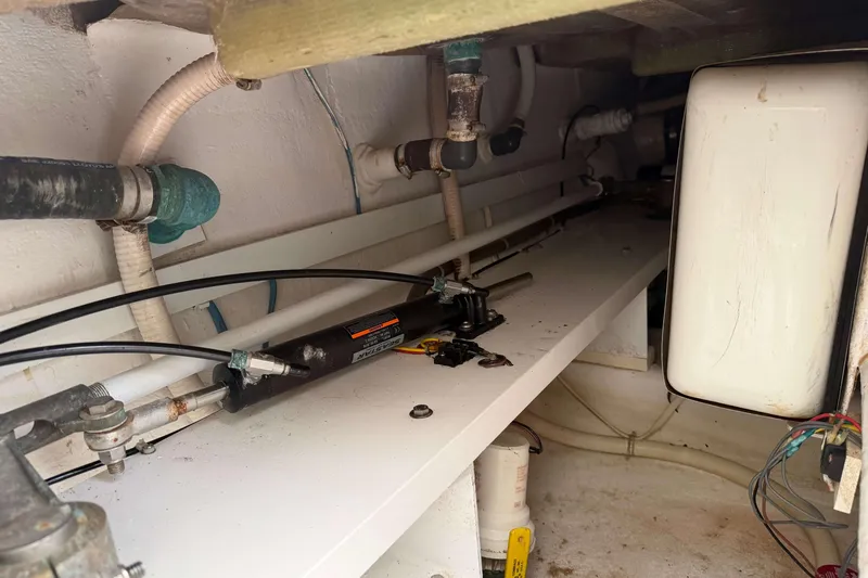 Slide: The Image of Engine compartment of a 2008 Henriques 30 Express boat, showing hydraulic and plumbing systems. - 8