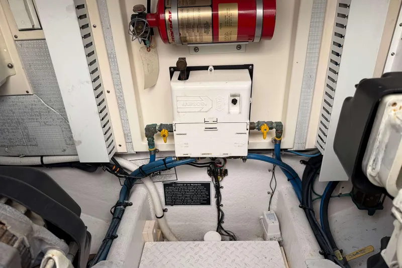Slide: The Image of Engine room of 2008 Henriques 30 Express boat with fire extinguisher and wiring. - 80
