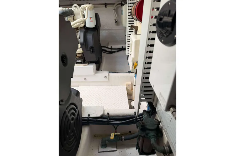 Slide: The Image of Engine room of a 2008 Henriques 30 Express boat, showcasing mechanical components. - 85