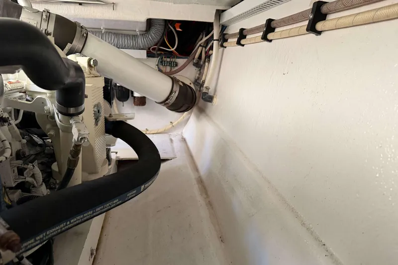 Slide: The Image of Engine room of 2008 Henriques 30 Express boat, showing pipes and wiring. - 87