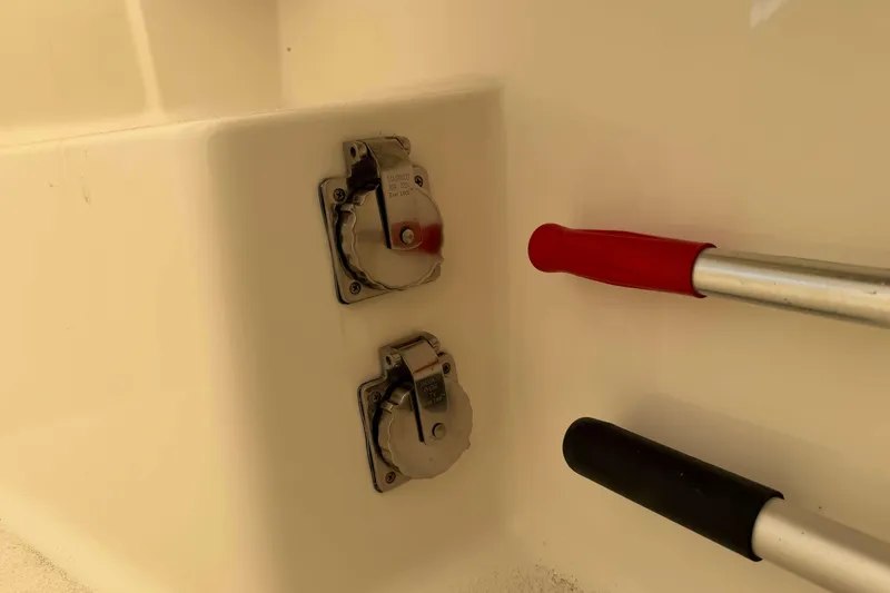 Slide: The Image of 2008 Henriques 30 Express boat power outlets and handles detail. - 9