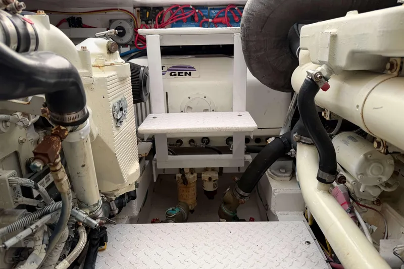 Slide: The Image of Engine room of 2008 Henriques 30 Express boat, showcasing mechanical components and wiring. - 92