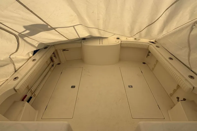 Slide: The Image of 2008 Henriques 30 Express boat interior under cover, showcasing spacious deck layout. - 94