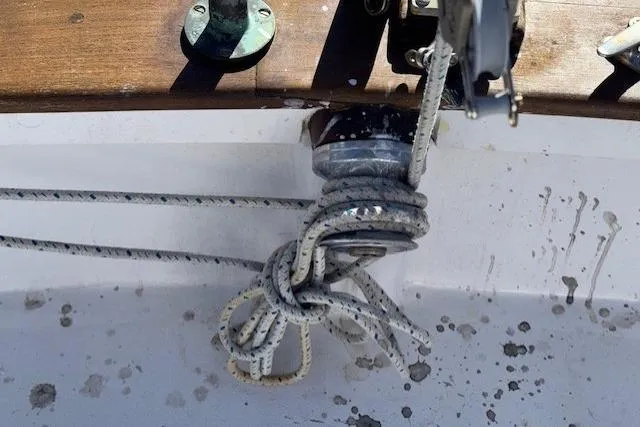 Slide: The Image of Deck view of 1980 Roughwater MOTOR SAILER, featuring winch and mooring lines. - 17