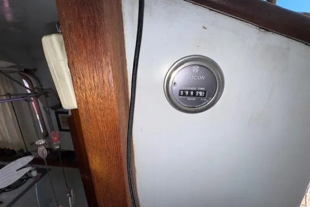 Slide: The Image of Engine compartment of 1980 Roughwater MOTOR SAILER, featuring a blue marine engine. - 19