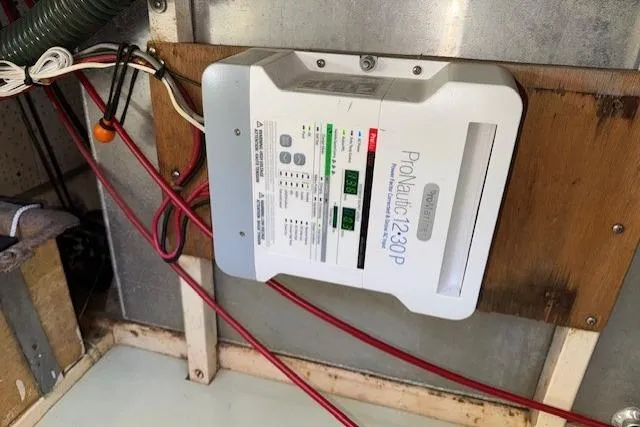 Slide: The Image of 1980 Roughwater MOTOR SAILER interior with elapsed time gauge on wooden panel. - 20