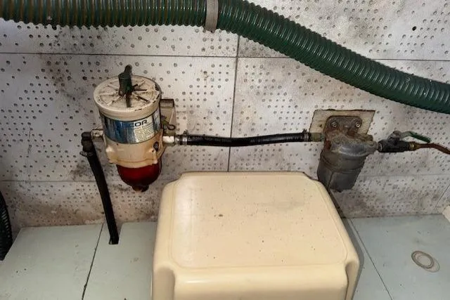 Slide: The Image of Engine room of 1980 Roughwater MOTOR SAILER with equipment and Shell oil containers. - 22