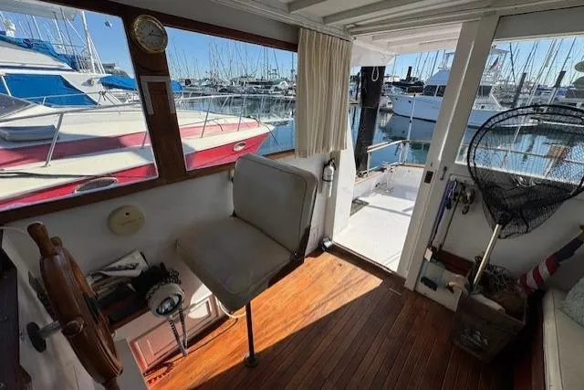 Slide: The Image of Interior view of 1980 Roughwater MOTOR SAILER with marina backdrop. - 4