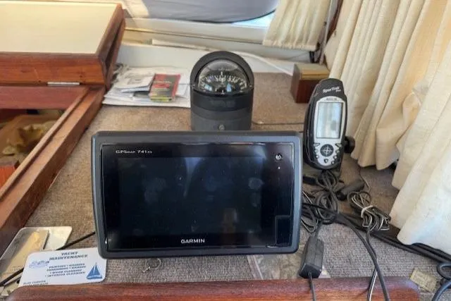 Slide: The Image of Navigation equipment on 1980 Roughwater MOTOR SAILER, featuring Garmin GPS and compass. - 7