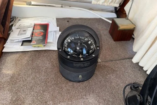 Slide: The Image of Compass on 1980 Roughwater MOTOR SAILER, surrounded by documents and equipment. - 9