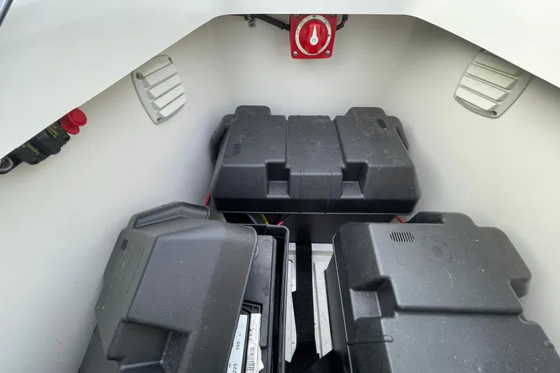 Slide: The Image of 2020 Regulator 26XO boat battery compartment with multiple battery boxes. - 12
