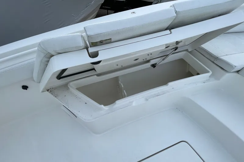 Slide: The Image of 2020 Regulator 26XO boat storage compartment with open cushioned seat. - 14