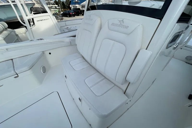 Slide: The Image of 2020 Regulator 26XO boat interior with white cushioned seating. - 15