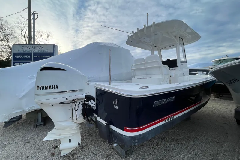 Slide: The Image of 2020 Regulator 26XO boat with Yamaha engine, displayed outdoors under a cloudy sky. - 2