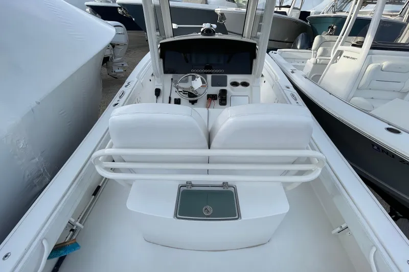 Slide: The Image of 2020 Regulator 26XO boat interior with helm, white seating, and console. - 20