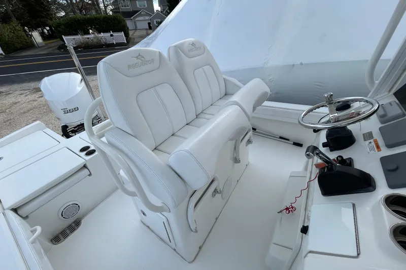 Slide: The Image of 2020 Regulator 26XO boat interior with white seating and steering wheel. - 22