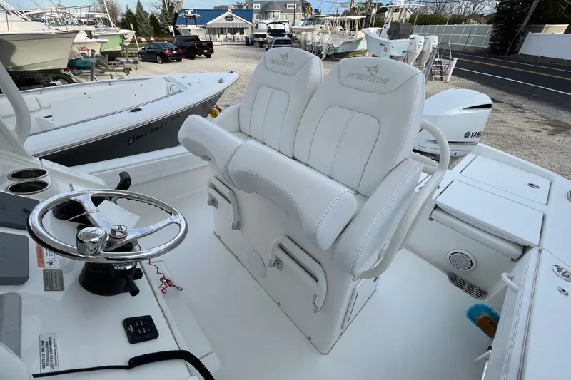 Slide: The Image of 2020 Regulator 26XO boat interior with white seating and steering wheel. - 23
