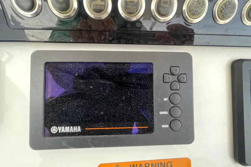 Slide: The Image of Yamaha display panel on 2020 Regulator 26XO boat dashboard with control buttons. - 28