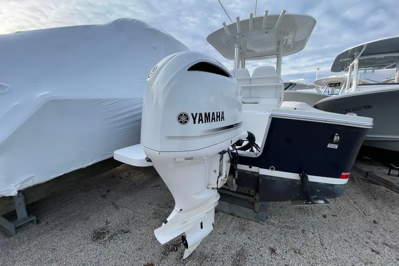 Slide: The Image of 2020 Regulator 26XO boat with Yamaha outboard motor, docked on gravel. - 3