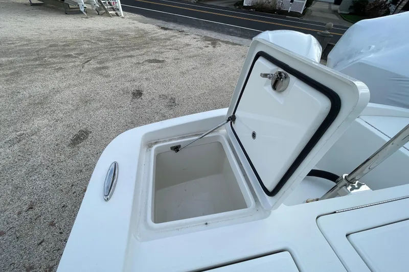 Slide: The Image of Open storage compartment on a 2020 Regulator 26XO boat, showing interior space. - 34