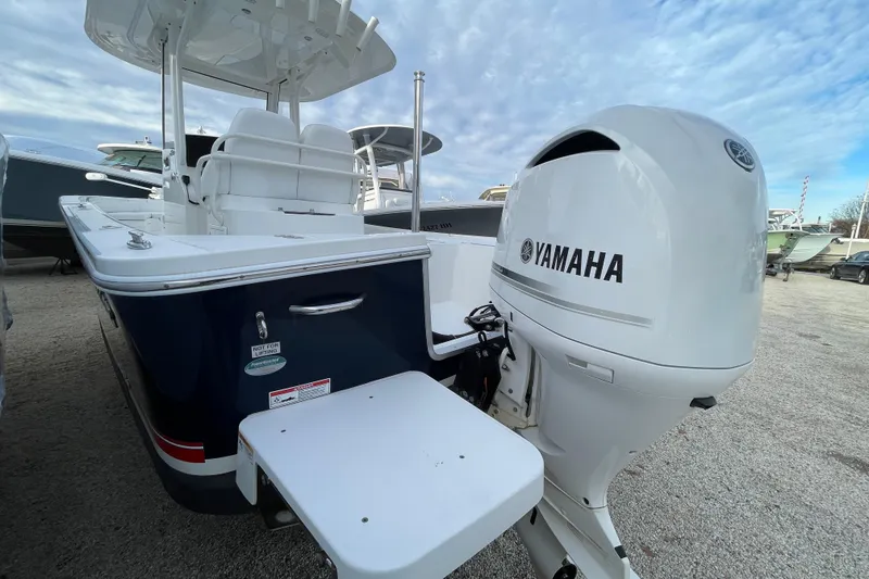 Slide: The Image of 2020 Regulator 26XO boat with Yamaha outboard motor, docked under a cloudy sky. - 4