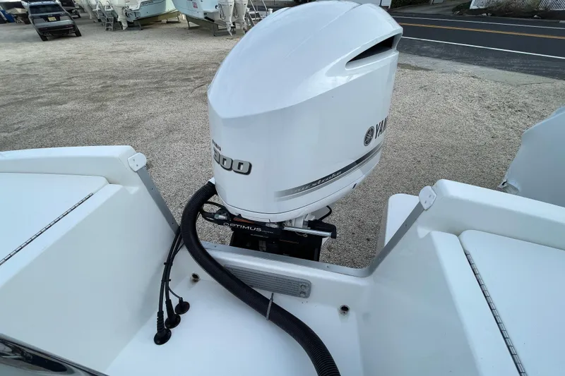 Slide: The Image of 2020 Regulator 26XO boat with Yamaha outboard engine, docked on gravel surface. - 5