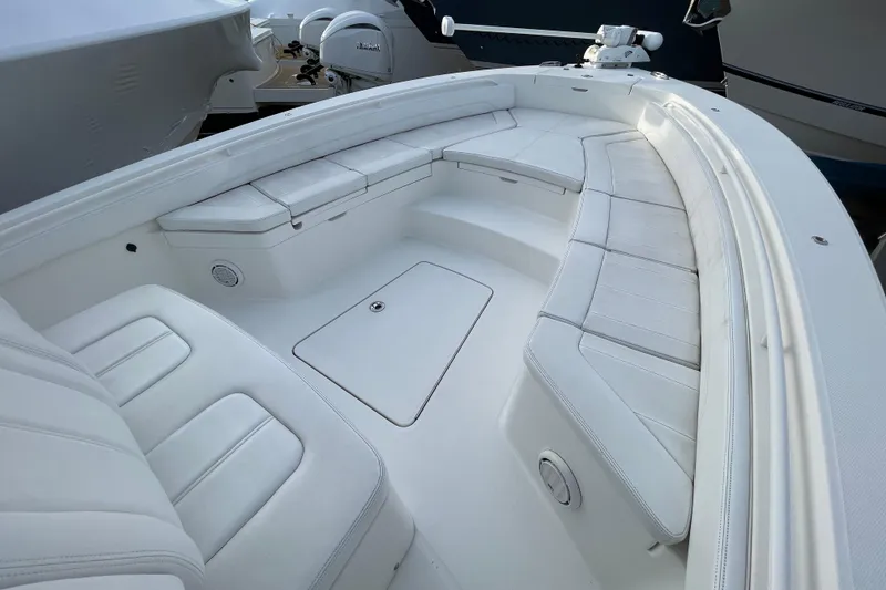 Slide: The Image of 2020 Regulator 26XO boat interior with white cushioned seating and storage compartments. - 9