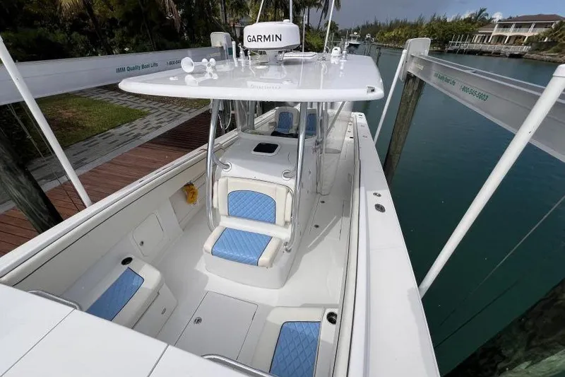 Slide: The Image of 2013 Jupiter 38 Cuddy boat with blue seating, docked in a serene canal. - 3