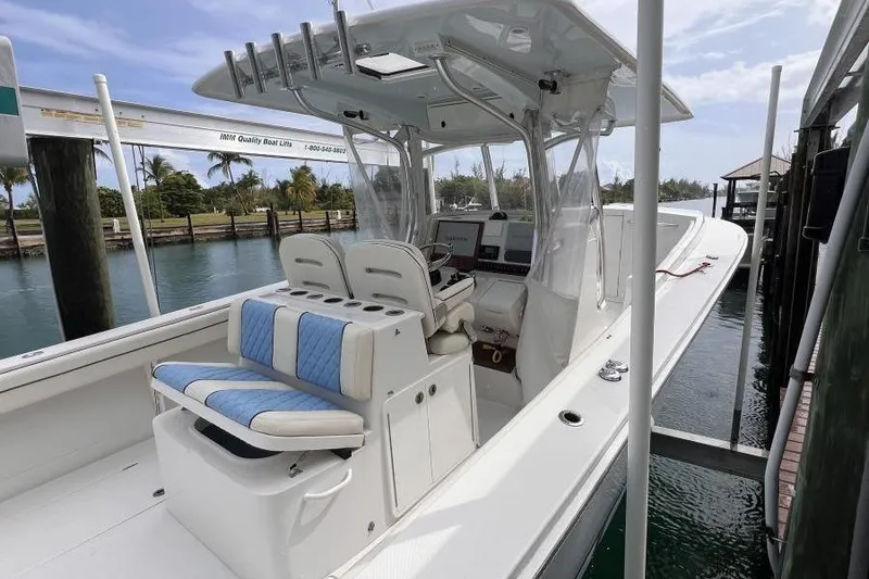 Slide: The Image of 2013 Jupiter 38 Cuddy boat docked, featuring spacious seating and modern helm. - 4