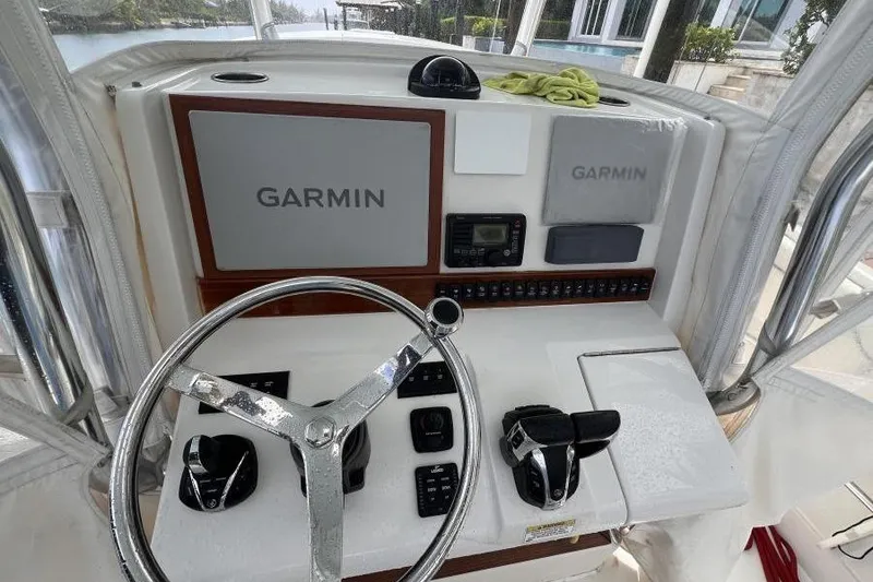 Slide: The Image of 2013 Jupiter 38 Cuddy helm with Garmin navigation system and steering wheel. - 5