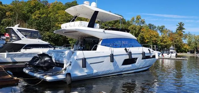 Slide: The Image of 2016 Prestige 560 luxury yacht docked in marina. - 1