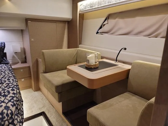 Slide: The Image of Interior of a 2016 Prestige 560 yacht with cozy seating area. - 24