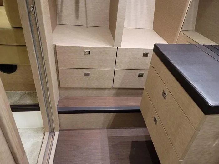 Slide: The Image of Interior of a 2016 Prestige 560 yacht, featuring drawers and steps. - 31
