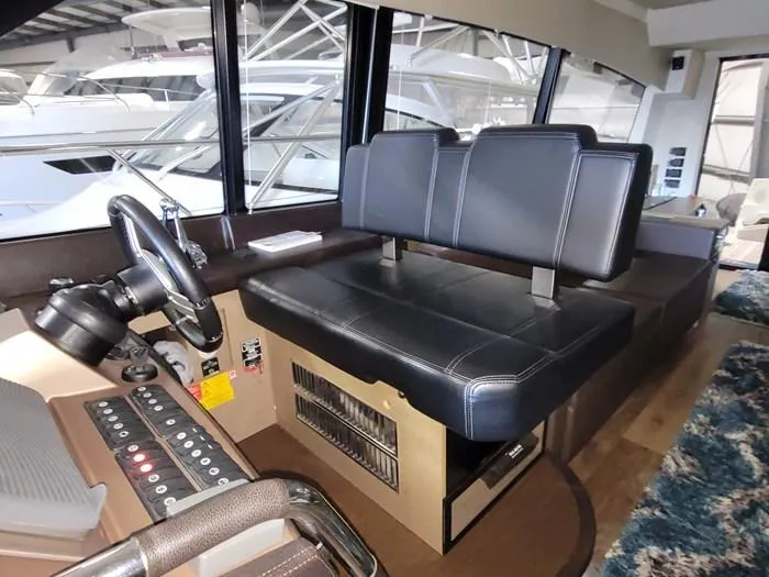 Slide: The Image of Interior of a 2016 Prestige 560 yacht with helm and seating area. - 6