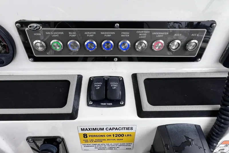 Slide: The Image of Control panel of a 2020 Sea Fox 228 Commander boat with various switches and capacity label. - 27
