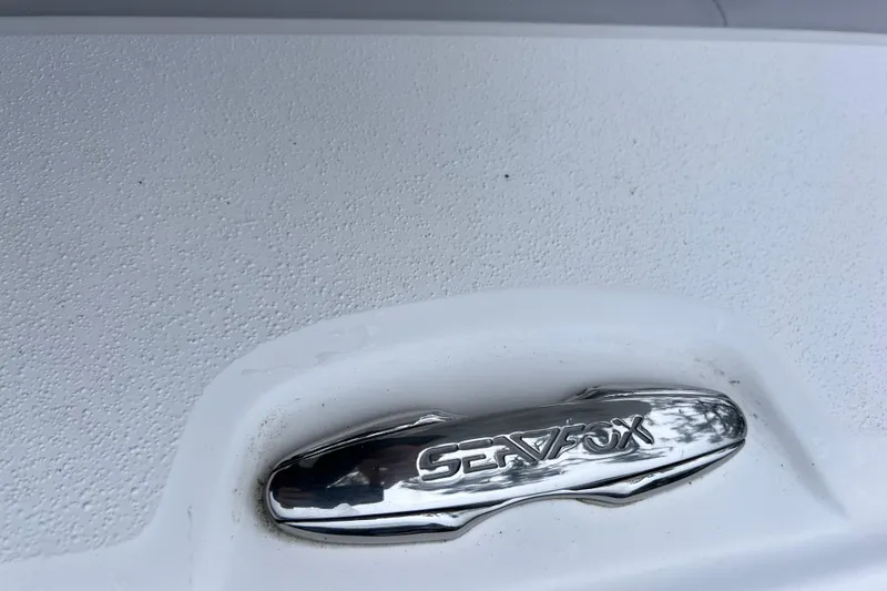 Slide: The Image of Chrome Sea Fox logo on 2020 Sea Fox 228 Commander boat surface. - 34