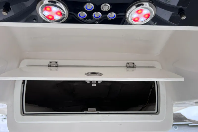 Slide: The Image of 2020 Sea Fox 228 Commander boat console with open storage compartment and LED lights. - 46
