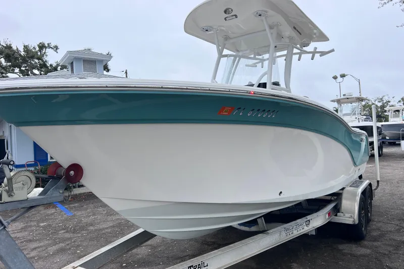 Slide: The Image of 2020 Sea Fox 228 Commander boat on trailer, white and teal design. - 5