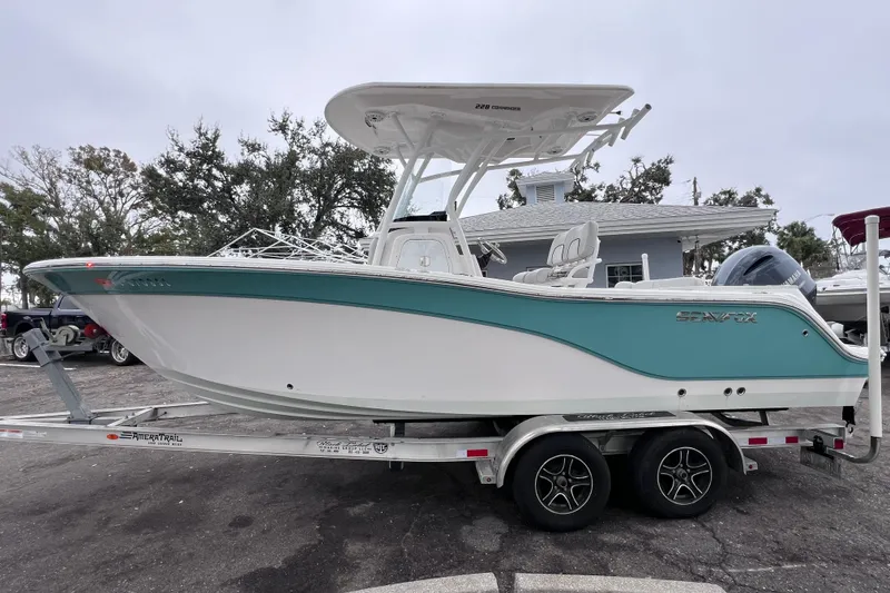 Slide: The Image of 2020 Sea Fox 228 Commander boat on trailer, featuring sleek design and teal accents. - 6