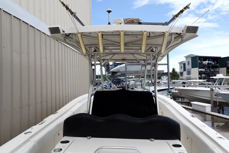 Slide: The Image of 2005 Hydra-Sports Vector 3300 CC boat docked at a marina, featuring fishing rod holders. - 3