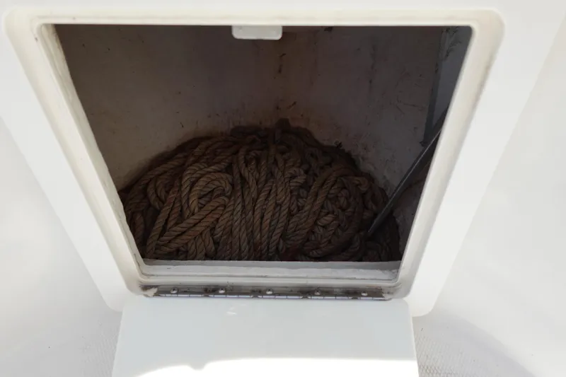 Slide: The Image of Storage compartment with coiled rope on a 2005 Hydra-Sports Vector 3300 CC boat. - 48