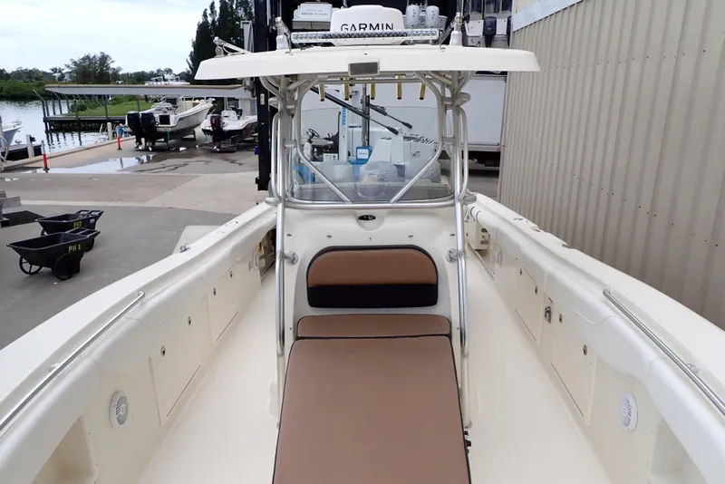 Slide: The Image of 2005 Hydra-Sports Vector 3300 CC boat interior at marina, featuring seating and navigation equipment. - 6