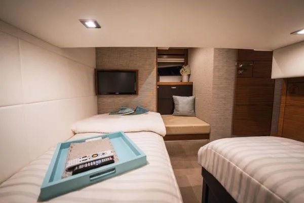 Slide: The Image of Luxurious 2016 Tiara Yachts C44 Coupe cabin with twin beds and modern decor. - 10