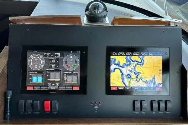 Slide: The Image of Dashboard of 2016 Tiara Yachts C44 Coupe with navigation and control screens. - 14