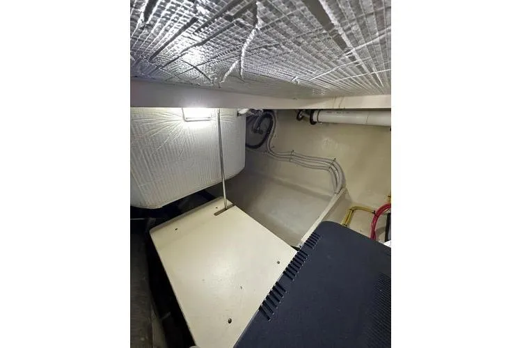 Slide: The Image of Engine room of 2016 Tiara Yachts C44 Coupe with visible insulation and wiring. - 16