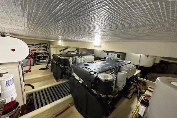 Slide: The Image of Engine room of 2016 Tiara Yachts C44 Coupe, showcasing dual engines and mechanical components. - 19