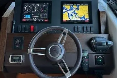 Slide: The Image of Dashboard of 2016 Tiara Yachts C44 Coupe with navigation screens and controls. - 3